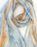 Colorful scarf with blue, orange, and white patterns on a white background